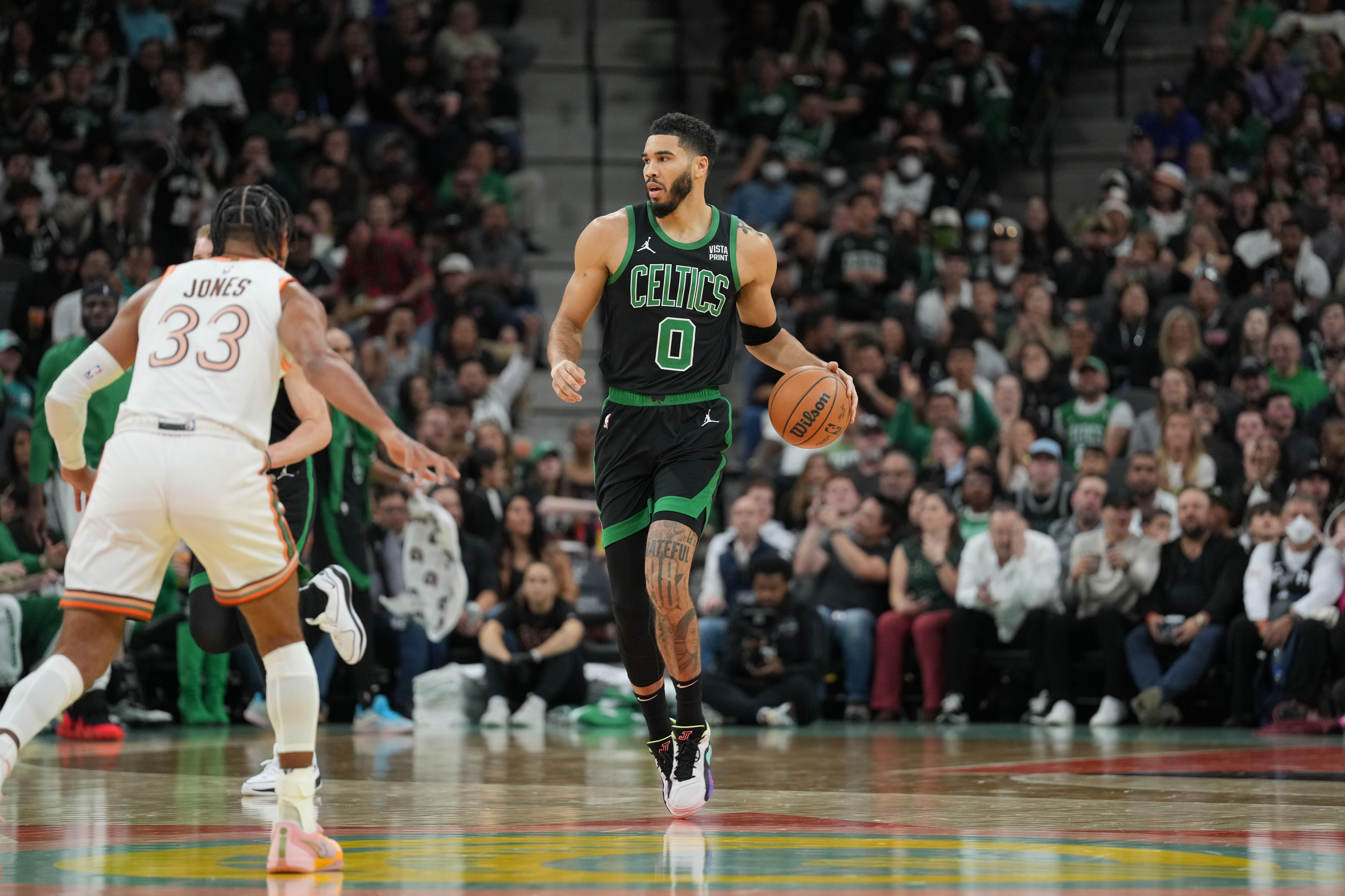 Dec 31, 2023; San Antonio, Texas, USA; Boston Celtics forward Jayson Tatum (0) dribbles the ball against San Antonio Spurs guard Tre Jones (33) in the first half at Frost Bank Center.